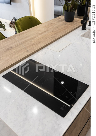 Induction cooktop on marble kitchen island countertop 137211515