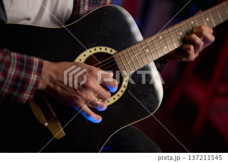 Close-Up of Guitarist Playing Acoustic Guitar 137211545