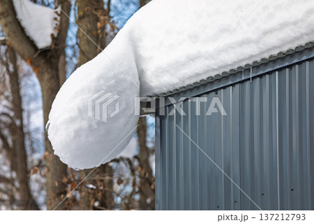 Heavy snow overhang on metal shed roof Heavy snow overhang on metal shed roof 137212793