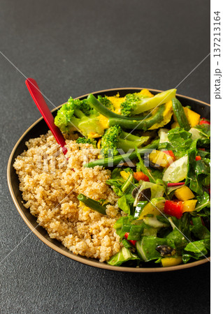 This healthy breakfast consists of a quinoa bowl served with boiled eggs, green beans, and broccoli, alongside a fresh salad. It offers a nutritious start to the day This healthy breakfast consists of a quinoa bowl served with boiled eggs, green beans, and broccoli, alongside a fresh salad. It offers a nutritious start to the day 137213164