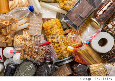Canned goods, cereals, and pasta stored for quarantine and isolation, ensuring long-term survival and food security at home, survival during military operations, the concept of stay at home 137213175