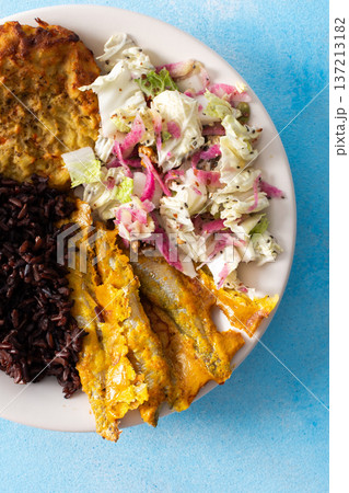 A wholesome and savory breakfast with brown rice and baked white fish, complemented by zucchini-carrot pancakes and a fresh Chinese cabbage salad with radish A wholesome and savory breakfast with brown rice and baked white fish, complemented by zucchini-carrot pancakes and a fresh Chinese cabbage salad with radish 137213182
