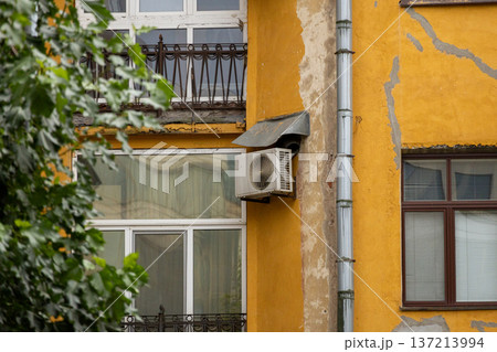 air conditioning on facade of building, air cooling in hot weather. air conditioning on facade of building, air cooling in hot weather. 137213994