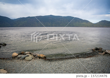 Early morning landscape of Teletskoye lake in Altai Russia. Calm water, soft light and serene mountain atmosphere near Artybash Early morning landscape of Teletskoye lake in Altai Russia. Calm water, soft light and serene mountain atmosphere near Artybash 137214476