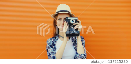 Portrait of young woman photographer with film camera, modern girl tourist taking a picture Portrait of young woman photographer with film camera, modern girl tourist taking a picture 137215280