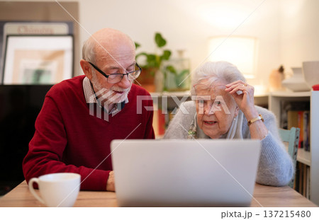 Old people having problem with laptop. 137215480