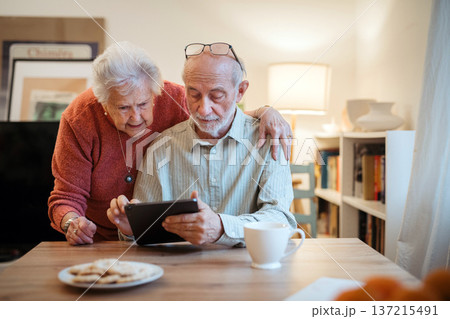 Senior coule working with tablet, booking online appointment with doctor. 137215491
