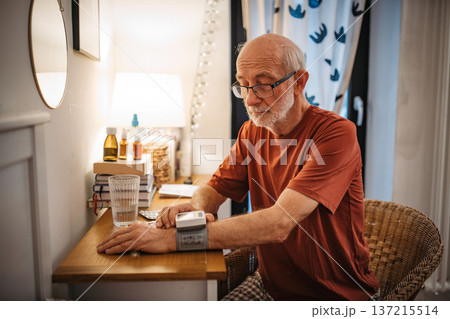 Senior man measuring blood pressure with wrist monitor. Senior man measuring blood pressure with wrist monitor. 137215514