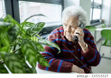 Senior facing phone scams and digital safety. 137215527