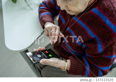 Senior facing phone scams and digital safety. 137215529