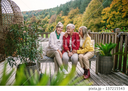 Portrait of three smiling senior women together outdoors. Portrait of three smiling senior women together outdoors. 137215543