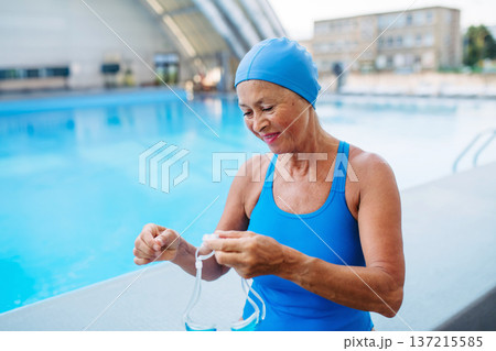 Senior woman getting ready for swim. 137215585