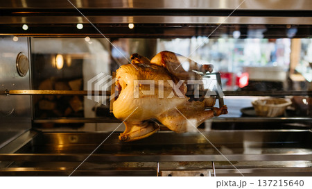 Rotisserie chicken cooking inside oven, roasted poultry preparation. 137215640