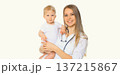 Happy smiling young woman doctor pediatrician holding little baby on white background 137215867