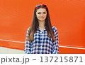 Summer portrait of happy cheerful stylish young woman posing on red background 137215871