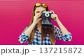 Portrait of young woman photographer with film camera, modern girl tourist taking a picture 137215872