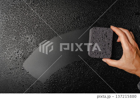 Sponge placed on wet black background 137215880