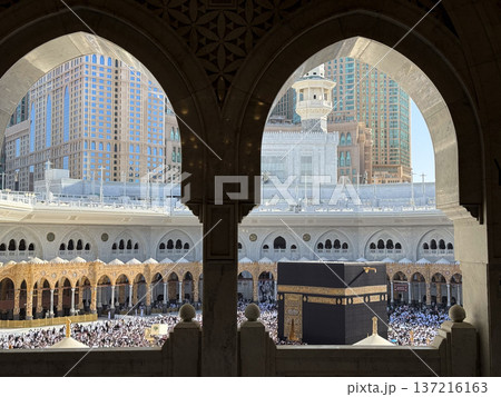 Pilgrims circling the Kaaba at Masjid al-Haram in Mecca with crowds framed by mosque arches Pilgrims circling the Kaaba at Masjid al-Haram in Mecca with crowds framed by mosque arches 137216163