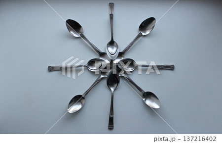 Flower Pattern Made With Variety Size Spoons On White Surface 137216402