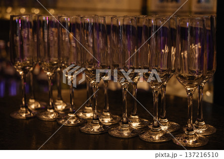 Champagne Glasses Awaiting Celebration. Sophisticated Setting Featuring Empty Flutes Champagne Glasses Awaiting Celebration. Sophisticated Setting Featuring Empty Flutes 137216510