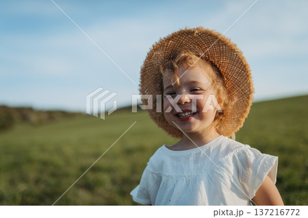 Cute girl playing on meadow, in spring nature. Cute girl playing on meadow, in spring nature. 137216772