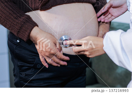 cropped shot of doctor examining pregnant woman during medical consultation 137216993