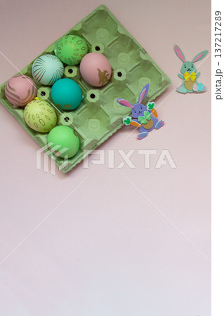 Easter eggs and small easter bunnies with pink background Easter eggs and small easter bunnies with pink background 137217289