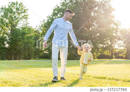 Park playtime. Parent and child spending quality time outdoors. 137217760