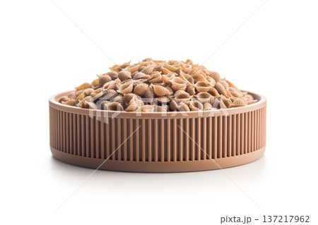 Wholegrain conchiglie pasta in bowl isolated on white background. 137217962