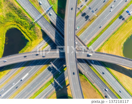 Aerial view of a multilevel highway interchange with busy car traffic. 137218117