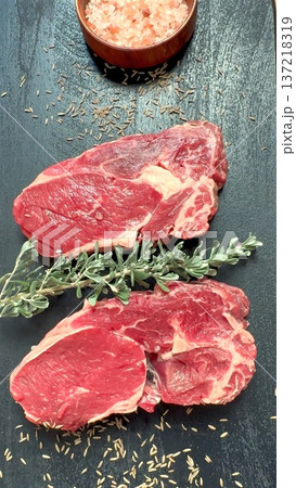 Uncooked Sirloin On Slate Ready To Cook, Fresh Raw Sirloin Cut Seasoned And Placed On Slate, Uncooked Beef Sirloin With Rosemary And Pink Salt Prepared For Grilling On Slate 137218319