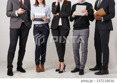 Business people teamwork. Busy team, partners working together at laptop, tablets and paper, copy space, crop 137218638