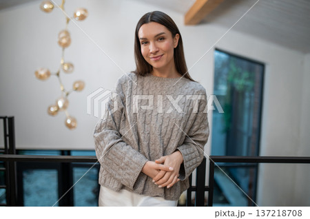 Lovely young woman feeling happy and contented spending time at home Lovely young woman feeling happy and contented spending time at home 137218708