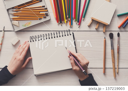 Draw in sketchbook. Creative artist workspace top view. Background of painting, art stationery Draw in sketchbook. Creative artist workspace top view. Background of painting, art stationery 137219003