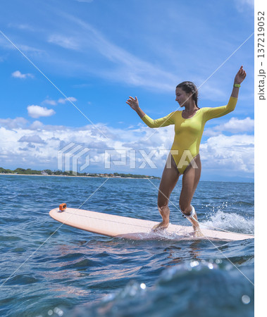 Dynamic Young Woman Performing Powerful Turn Amid Crashing Waves And Clouds Dynamic Young Woman Performing Powerful Turn Amid Crashing Waves And Clouds 137219052