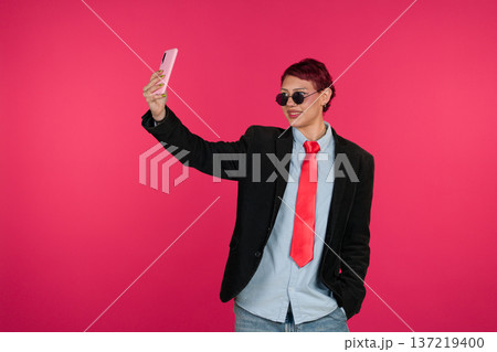 Young person taking selfie with smartphone Young person taking selfie with smartphone 137219400