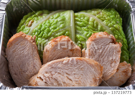Healthy lunch in foil container top view. Healthy food take away and delivery. Chicken and lettuce in box Healthy lunch in foil container top view. Healthy food take away and delivery. Chicken and lettuce in box 137219773