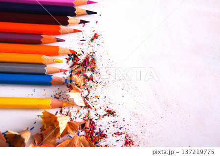 Drawing tools background. Lot of colorful pencils frame with sawdust and shavings on white, copy space, flat lay Drawing tools background. Lot of colorful pencils frame with sawdust and shavings on white, copy space, flat lay 137219775