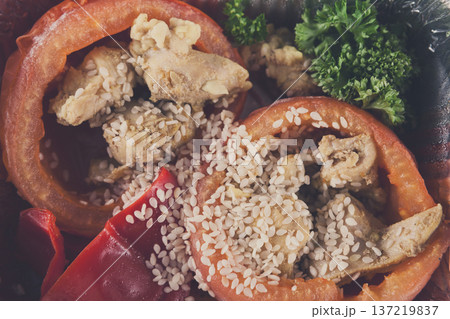 Healthy lunch in foil container. Healthy food take away and delivery. Bell pepper stuffed with chicken, broccoli, sesame, closeup Healthy lunch in foil container. Healthy food take away and delivery. Bell pepper stuffed with chicken, broccoli, sesame, closeup 137219837