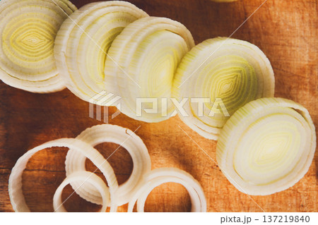 Cooking healthy food. Sliced and chopped leek closeup on wood background Cooking healthy food. Sliced and chopped leek closeup on wood background 137219840