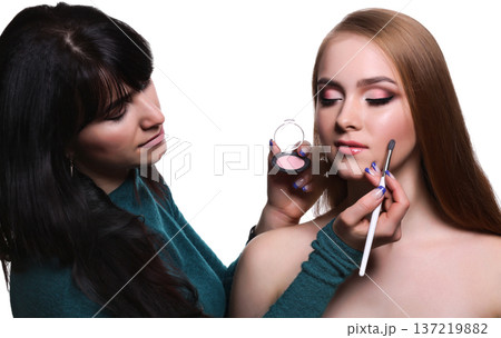 Make-up artist applying makeup for beauty model with eyeshadow palette, isolated on white background 137219882