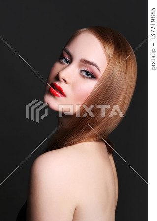 Beauty model on black background, fashion shooting. Woman with makeup, perfect skin and hair posing to camera at studio Beauty model on black background, fashion shooting. Woman with makeup, perfect skin and hair posing to camera at studio 137219885