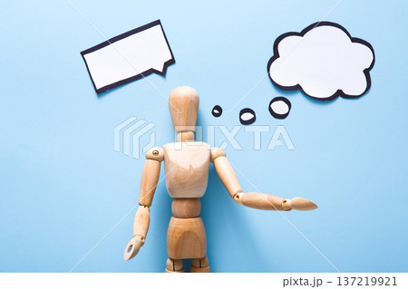 Handcrafted wooden man figure mannequin model dummy doll with blank speech bubble on blue background,objects, nobody Handcrafted wooden man figure mannequin model dummy doll with blank speech bubble on blue background,objects, nobody 137219921