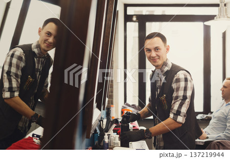 Barber ready for client. Professional haitstylist in male barbershop Barber ready for client. Professional haitstylist in male barbershop 137219944