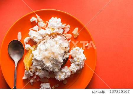 Healthy breakfast, dieting and detox concept - fresh cottage cheese on plate on bright orange background. Still life, flat lay, top view, copy space Healthy breakfast, dieting and detox concept - fresh cottage cheese on plate on bright orange background. Still life, flat lay, top view, copy space 137220167