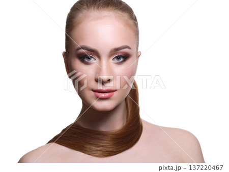Beauty model isolated on white background, fashion shooting. Woman with makeup, perfect skin and hair posing to camera at studio Beauty model isolated on white background, fashion shooting. Woman with makeup, perfect skin and hair posing to camera at studio 137220467