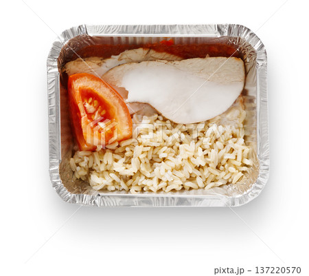 Healthy lunch in foil container. Healthy food take away and delivery. Meat, rice and tomato in box on white background, closeup, isolated 137220570