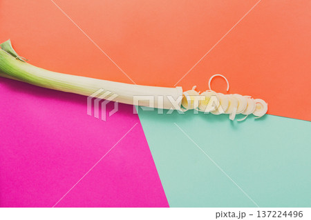 Cooking healthy food. Sliced and chopped leek on abstract colorful background, top view, copy space Cooking healthy food. Sliced and chopped leek on abstract colorful background, top view, copy space 137224496