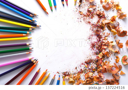 Drawing tools background. Lot of colorful pencils frame with sawdust and shavings on white, copy space, flat lay Drawing tools background. Lot of colorful pencils frame with sawdust and shavings on white, copy space, flat lay 137224516