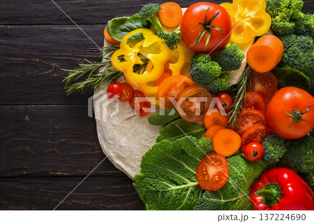 Cooking healthy vegetarian food background. Fresh organic vegetables on black. Natural food with copy space. Cooking healthy vegetarian food background. Fresh organic vegetables on black. Natural food with copy space. 137224690